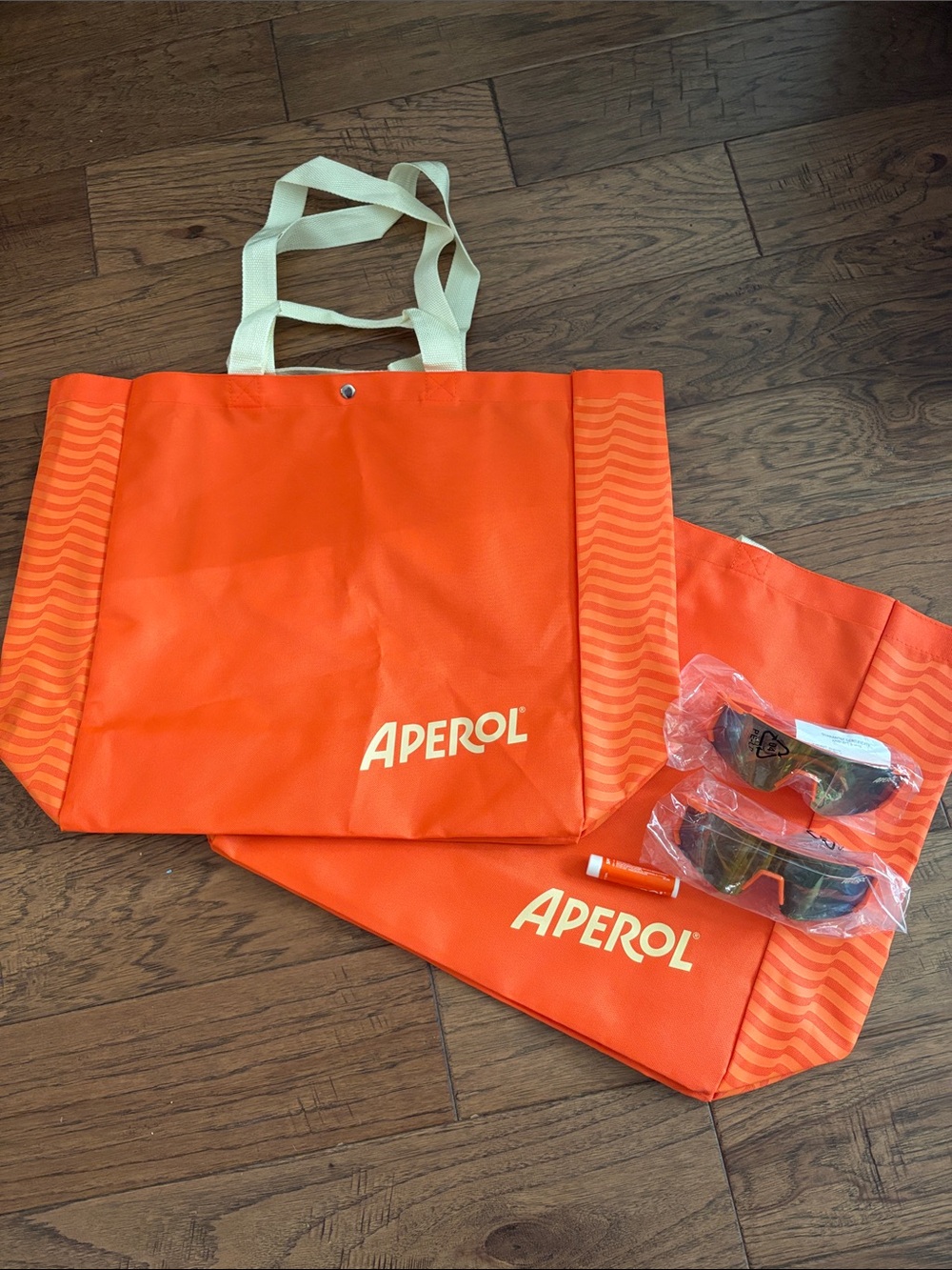 Aperol Beach Kit Orange Tote Bag, two sunglasses 🕶️, chapstick
